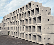 rows of stacked precast concrete products in a yard